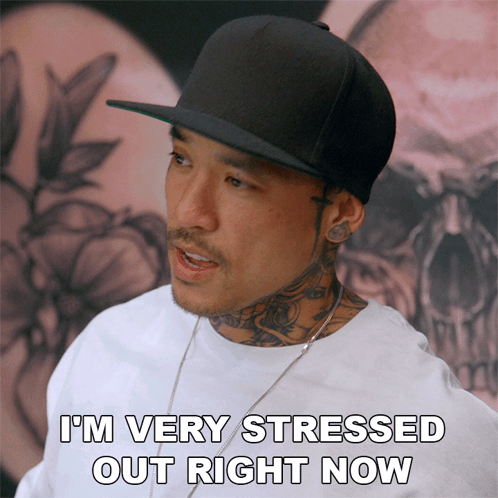 Stressed Man in Black Hat and White Shirt