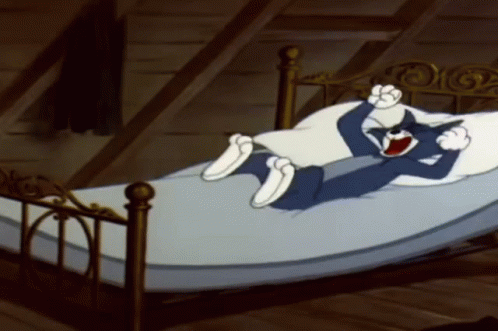 Tom Doing Limb Stretch In Bed GIF