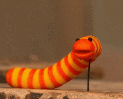Striped Worm Sticking Out of Wall