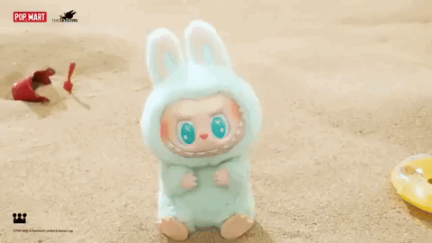 Stuffed Animal in Bunny Costume Sitting on Beach