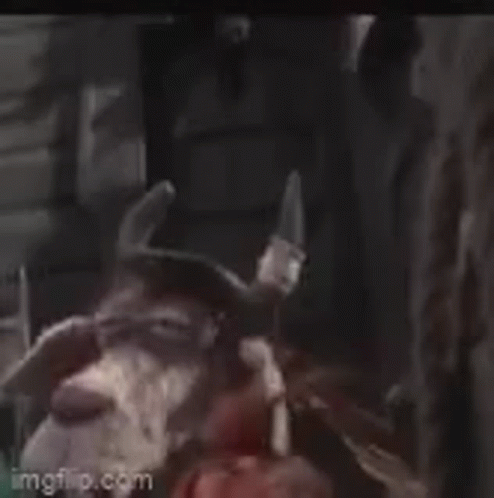 Stuffed Animal With Big Eyes And Horns Next To Person GIF