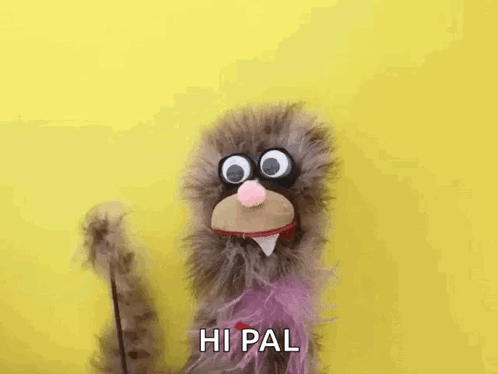 Stuffed Animal With Big Eyes And Purple Tail Waving GIF