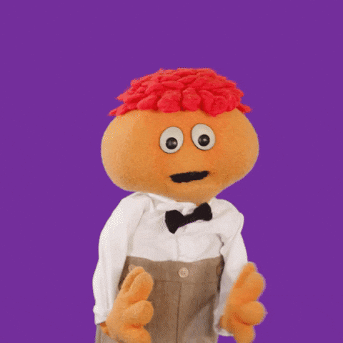 Stuffed Animal With Big Eyes And Red Hair In Tuxedo GIF