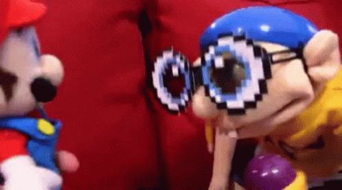 Stuffed Animal With Glasses Next to One With Hat