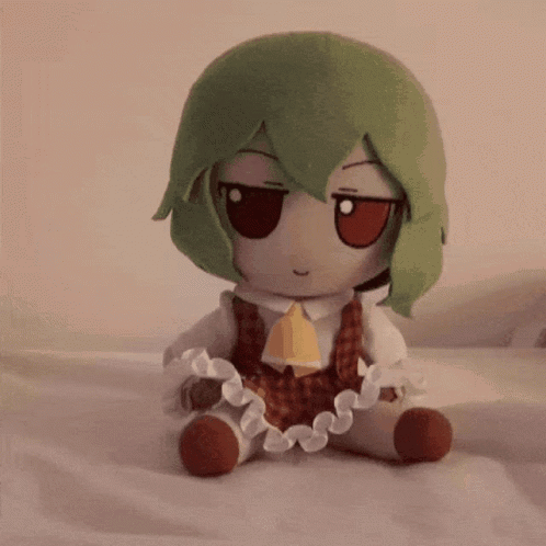 Stuffed Animal With Green Hair Sitting GIF