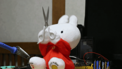 Stuffed Animal with Scissors in Mouth