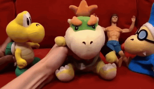 Stuffed Animals on Red Couch With Bowser
