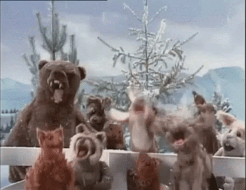 Stuffed Animals Standing Behind Fence GIF