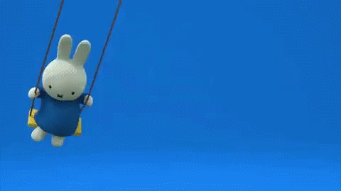Stuffed Bunny Sitting on Yellow Swing