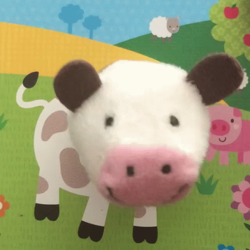 Stuffed Cow With Pink Nose Lying on Mat