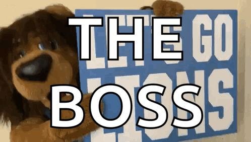Stuffed Dog Holding Sign Saying The Go Boss GIF