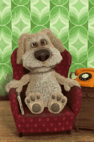 Stuffed Dog Sitting In Red Chair GIF