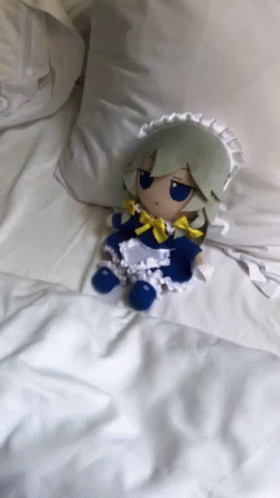 Stuffed Doll in Maid Outfit on Bed