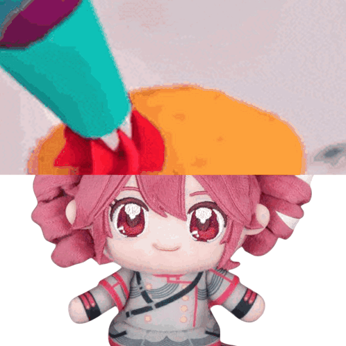Stuffed Doll With Pink Hair and Red Eyes Being Painted