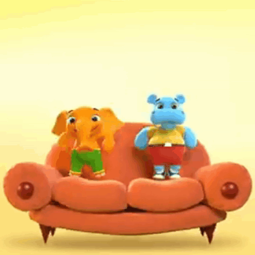 Stuffed Elephant and Hippo Sitting on Orange Couch