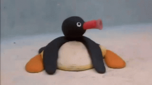 Stuffed Penguin Blowing Balloon