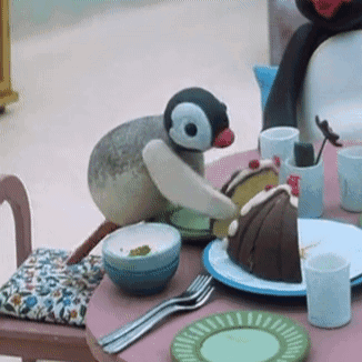 Stuffed Penguin Sitting With Cake