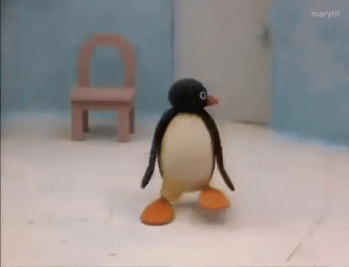 Stuffed Penguin Walking on Snow