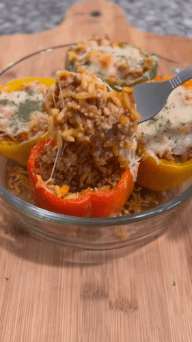 Stuffed Peppers In A Glass Bowl With A Fork GIF