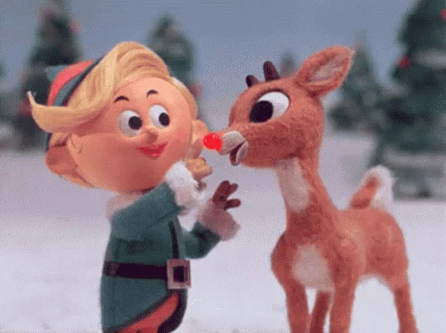 Stuffed Reindeer And Elf Standing In Snow GIF
