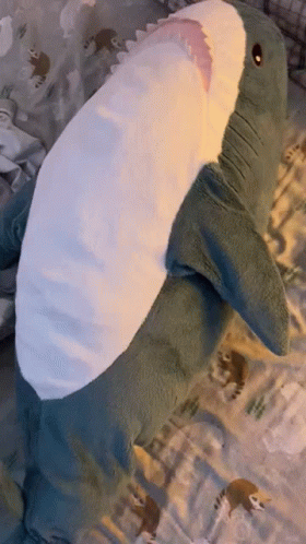 Stuffed Shark Laying on Bed