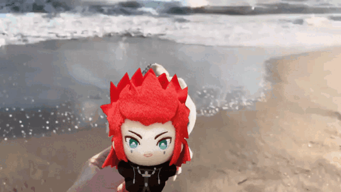 Stuffed Toy With Red Hair and Green Eyes on Beach