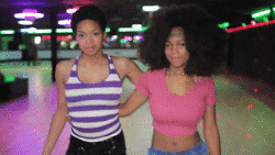 Stylish Afro Haired Women Strolling Confidently GIF