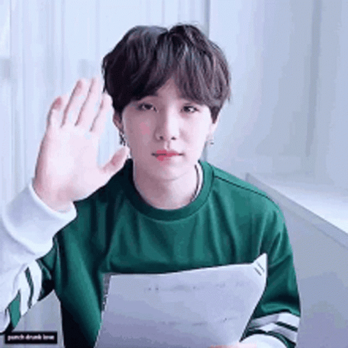 Suga Holding Paper While Saying Goodbye GIF