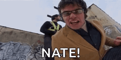 Suit and Glasses Man Yelling at Graffiti Wall
