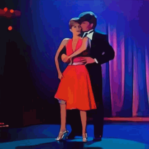 Suit-and-Tie Man Dancing with Woman in Red Dress