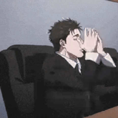 Suit and Tie Man Hands Folded on Couch