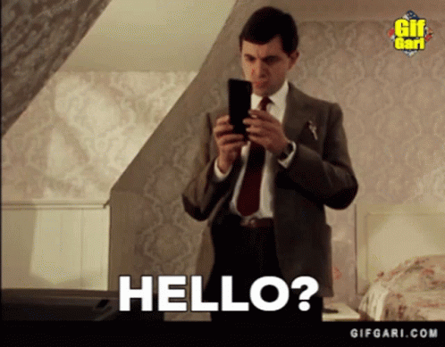 Suit And Tie Man Holding Cell Phone Saying Hello GIF
