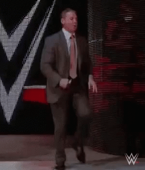 Suit And Tie Man Walking Down Stage GIF