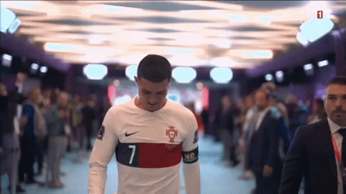 Suit-and-Tie Man with Soccer Player in White