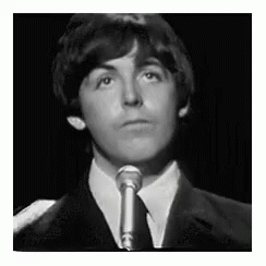 Suit-and-Tie Young Man Singing Into Microphone