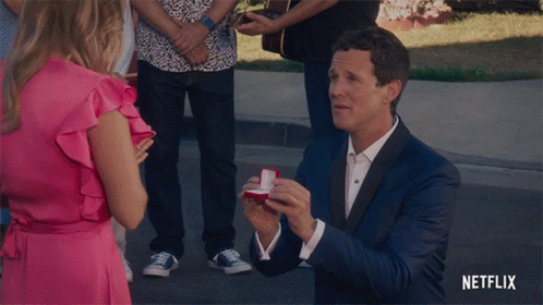 Suit Man Proposing Woman Pink Dress Netflix Logo