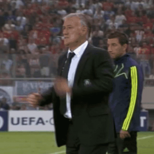 Suited Man At UEFA Sign On Soccer Field GIF