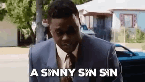 Suited Man Blue Car Says Synny Syn Syn