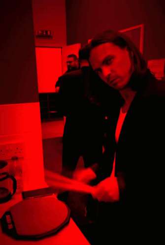 Suited Man in Dark Room with Red Light Saying Ikea