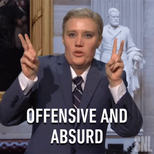 Suited Man Making Peace Sign Saying Offensive Absurd GIF