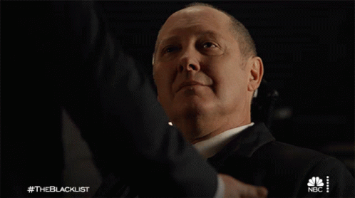 Suited Man Shaking Hands With NBC Logo GIF