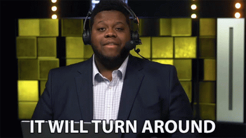 Suited Man With Headphones Saying It Will Turn Around