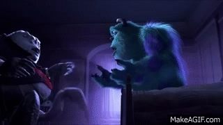 Sulley From Monsters Inc Is Sitting On A Bed Talking To A Man . GIF