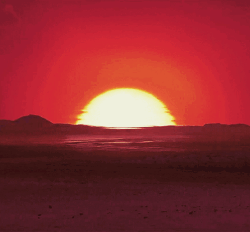 Sun Setting Over Desert Mountains GIF