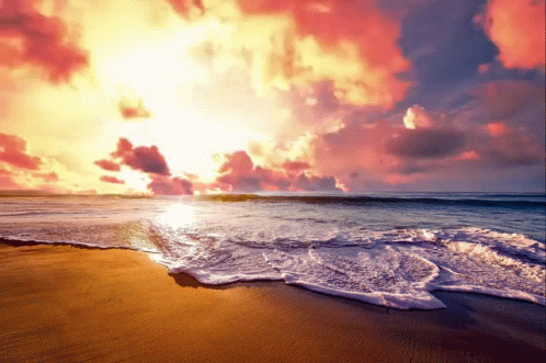 Sun Setting Over Ocean Waves Crashing on Sand
