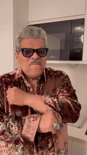 Sunglasses Man in Floral Shirt at Microwave