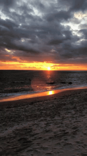 Sunset Over Ocean With Few Clouds