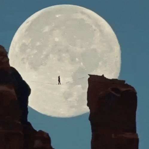 Super Moon And Man Crossing Hanging Bridge GIF