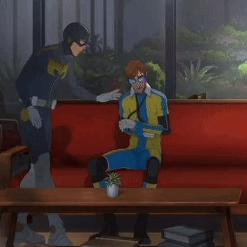 Superhero Man and Another Man on Red Couch