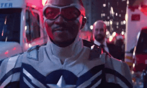 Superhero Man in Front of Ambulance at Night